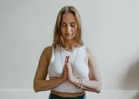 A serene image of a woman practicing meditation indoors, promoting mindfulness and wellbeing.